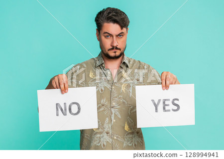 Man holding yes and no signs offering choice decision-making opportunity question voting selection Man holding yes and no signs offering choice decision-making opportunity question voting selection 128994941