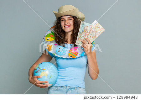 Woman tourist with globe map inflatable ring recommending vacation travel sea holiday advertisement Woman tourist with globe map inflatable ring recommending vacation travel sea holiday advertisement 128994948