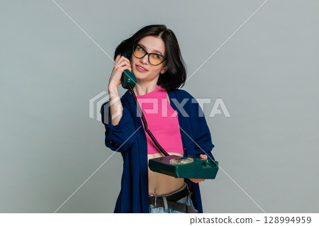 Woman emotionally talking on retro wired phone explaining something actively expressive reaction 128994959