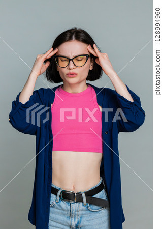 Woman holding head with hands showing pain discomfort headache emotional stress facial reaction 128994960