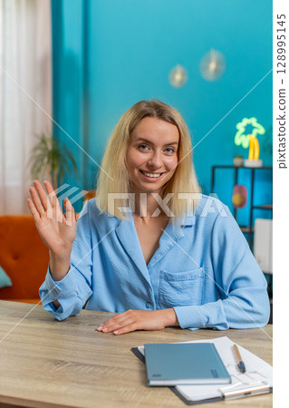 Portrait of young smiling Caucasian business woman at home office workplace desk look at camera 128995145