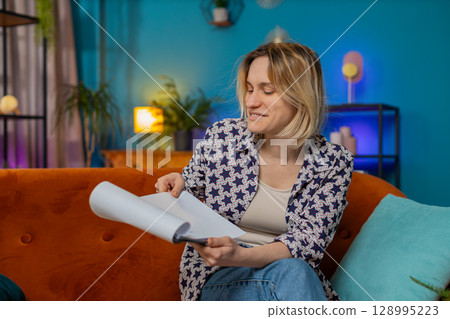 Woman freelancer work with documents from home, analyzing information read business financial report 128995223