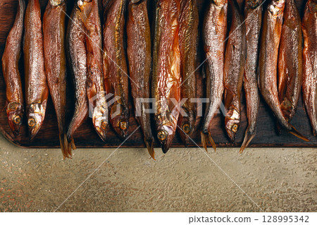 cold smoked capelin, on a wooden chopping board, no people, 128995342