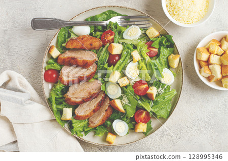 Caesar salad, with duck breast, on a light plate, on a light background, homemade, no people, Caesar salad, with duck breast, on a light plate, on a light background, homemade, no people, 128995346