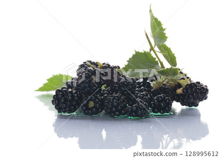 Natural blackberries close-up with leaves 128995612