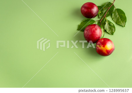 Three juicy plums with a blush close-up on the table 128995637