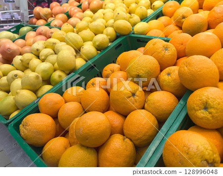Colorful citrus display at a bustling market during the afternoon Colorful citrus display at a bustling market during the afternoon 128996048