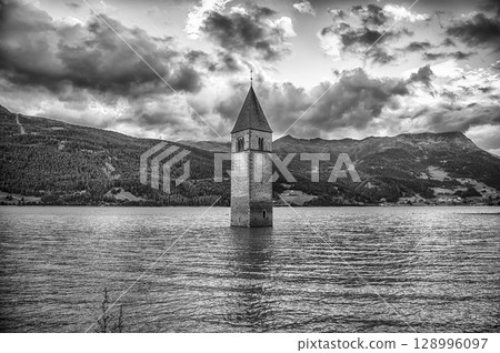 The iconic submerged Church Tower of Graun, Lake Reschensee, Italy The iconic submerged Church Tower of Graun, Lake Reschensee, Italy 128996097