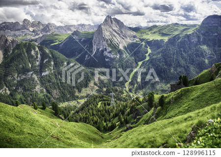 Colac mountain dominating the Italian Dolomites landscape near Canazei, Italy 128996115
