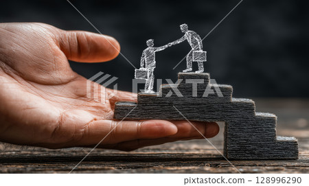 Support and collaboration shown via a human hand and chalk figures 128996290