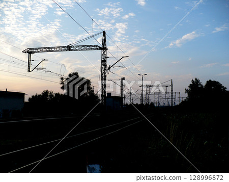 sunset over traction railroad tracks 128996872