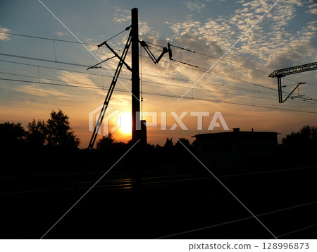 sunset over traction railroad tracks 128996873