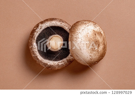 Raw Portobello Mushrooms on Pastel Brown Background 128997029
