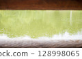 Rain drops on the water, through two wooden beams. An autumnal concept, and an empty space for your advertising. 128998065
