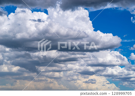Cumulus and cumulonimbus clouds covering the summer sky a-1 Cumulus and cumulonimbus clouds covering the summer sky a-1 128999705