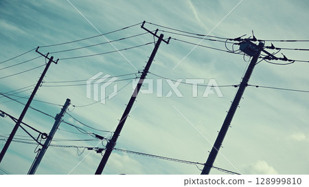 Power lines and poles Power lines and poles 128999810