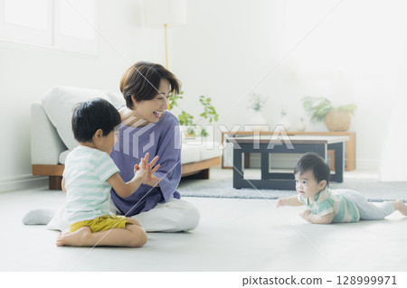 Parents and children relaxing in the living room Parents and children relaxing in the living room 128999971