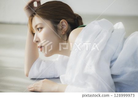 A woman lying on the floor 128999973