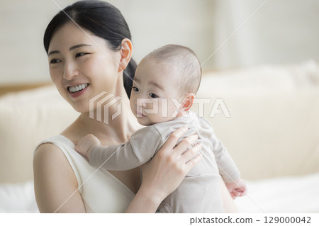 Mother holding a baby Mother holding a baby 129000042