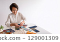 Senior woman doing handicraft 129001309