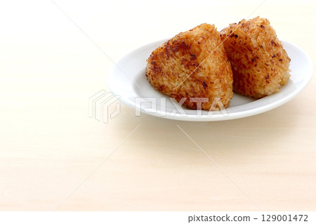 Homemade grilled rice balls on the table background Homemade grilled rice balls on the table background 129001472