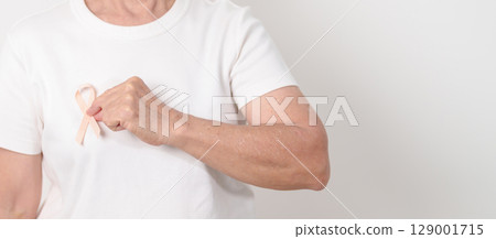 Elderly woman with Peach Ribbon for September Uterine Cancer Awareness month, Endometrial Cancer, Gynecologic, Uterus and Ovaries, Endometriosis, June Vaginal cancer and World cancer day concept 129001715