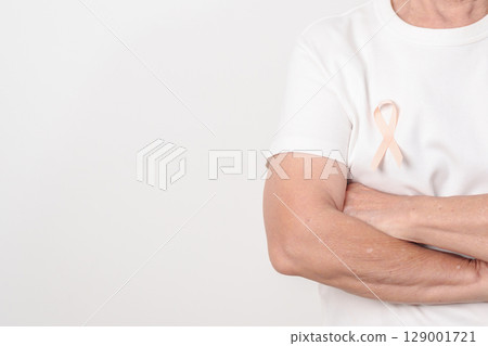 Elderly woman with Peach Ribbon for September Uterine Cancer Awareness month, Endometrial Cancer, Gynecologic, Uterus and Ovaries, Endometriosis, June Vaginal cancer and World cancer day concept 129001721