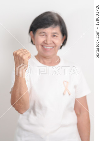 Elderly woman with Peach Ribbon for September Uterine Cancer Awareness month, Endometrial Cancer, Gynecologic, Uterus and Ovaries, Endometriosis, June Vaginal cancer and World cancer day concept Elderly woman with Peach Ribbon for September Uterine Cancer Awareness month, Endometrial Cancer, Gynecologic, Uterus and Ovaries, Endometriosis, June Vaginal cancer and World cancer day concept 129001726