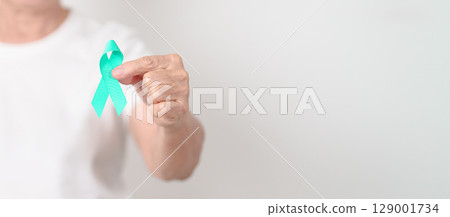 Elderly with Teal Ribbon for September Ovarian Cancer Awareness month, PCOS, January Cervical Cancer, April Sexual Assault, June PSTD, Post Traumatic Stress Disorder, May Tourette syndrome Elderly with Teal Ribbon for September Ovarian Cancer Awareness month, PCOS, January Cervical Cancer, April Sexual Assault, June PSTD, Post Traumatic Stress Disorder, May Tourette syndrome 129001734