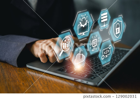 Explore cutting-edge information technology with digital icons and laptop interaction, showcasing modern business solutions. 129002031