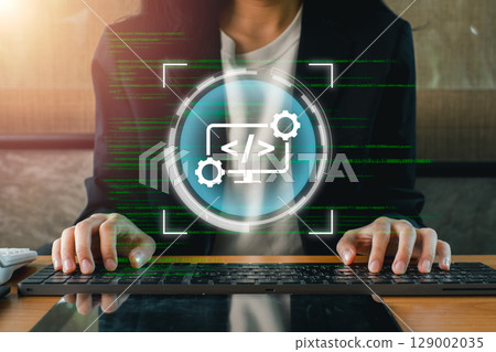 A web developer typing on a keyboard with digital code and interface elements overlay, symbolizing modern web development. 129002035