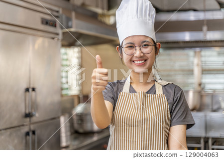 Confident Young Asian Female Chef in Kitchen 129004063