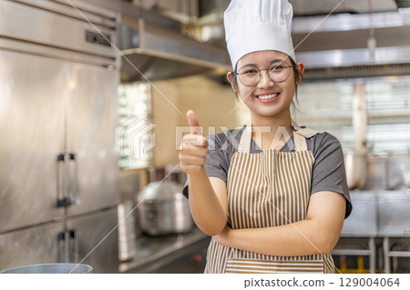 Confident Young Asian Female Chef in Kitchen 129004064