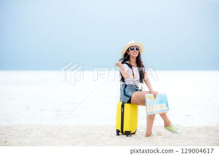 Happy traveler and tourism young women travel summer on the beach. 129004617