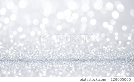 Abstract silver Christmas background with sparkling snowflakes and bright bokeh lights Abstract silver Christmas background with sparkling snowflakes and bright bokeh lights 129005000