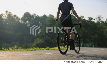 Woman cycling without hold the handlebaron summer tropical park trail 129005023