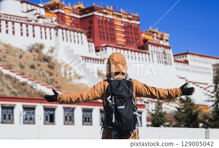 Woman tourist open arms to the potala palace in Lhasa city,Tibet,China 129005042