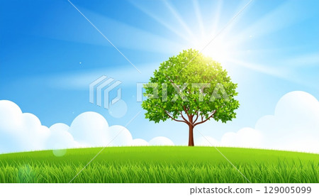 A lone tree stands majestically in a vast green field under a clear blue sky, illustrating the serene beauty of a natural summer landscape 129005099
