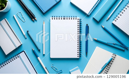 Open spiral notebook with a pen and pencil on a blank sheet of paper Open spiral notebook with a pen and pencil on a blank sheet of paper 129005196