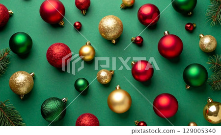 Gold, red, and green glass baubles and other ornaments decorate a festive pine branch for the Christmas holiday season 129005340