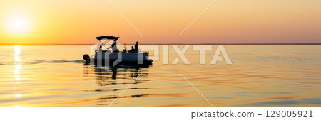 Sunset Fishing Trip on the Baltic Sea A Serene Evening Cruise Adventure, Calm Waters. 129005921