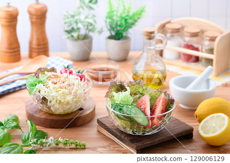 A table of colorful vegetable salads drizzled with olive oil 129006129