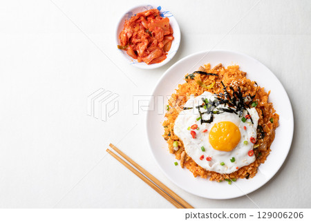 Korean kimchi fried rice with fried egg, pork, sesame seed, chili, spring onion and seaweed Korean kimchi fried rice with fried egg, pork, sesame seed, chili, spring onion and seaweed 129006206
