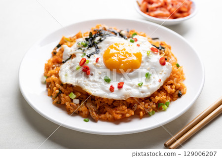 Korean kimchi fried rice with fried egg, pork, sesame seed, chili, spring onion and seaweed Korean kimchi fried rice with fried egg, pork, sesame seed, chili, spring onion and seaweed 129006207