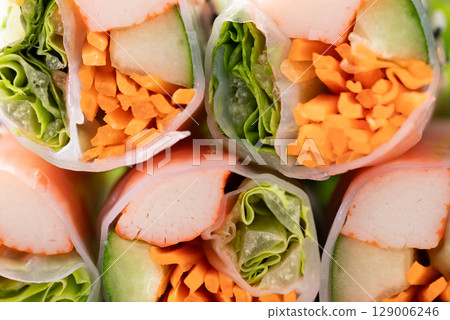 Salad roll with crab stick, carrot, cucumber and lettuce wrapped with rice paper Salad roll with crab stick, carrot, cucumber and lettuce wrapped with rice paper 129006246