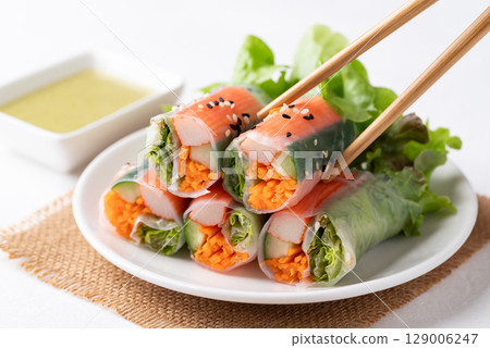 Salad roll with crab stick, carrot, cucumber and lettuce wrapped with rice paper Salad roll with crab stick, carrot, cucumber and lettuce wrapped with rice paper 129006247