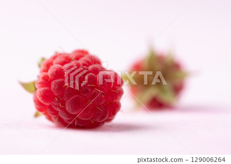 Fresh ripe raspberry with leaf on pink background, Summer fruit 129006264