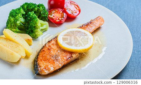 Salmon meuniere and vegetables on a plate Salmon meuniere and vegetables on a plate 129006316
