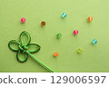 Background material using clover mizuhiki decorations and beads. Background color: yellow-green 129006597