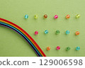 A background of rainbow and border-like beads. Background color: yellow-green 129006598
